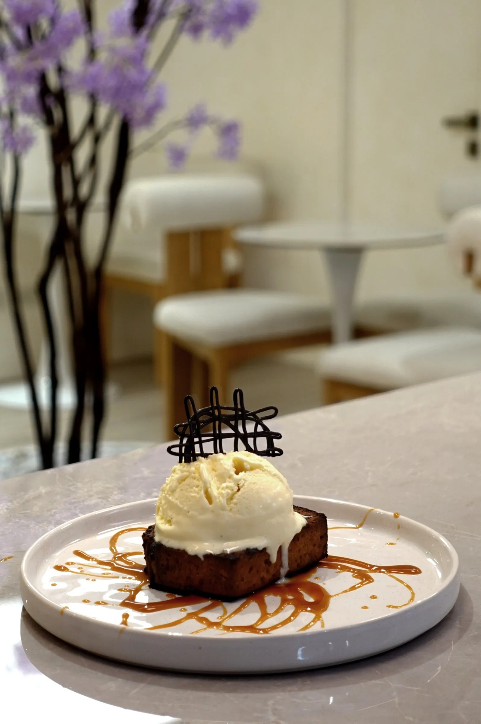 Warm chocolate cake with vanilla ice cream at the Lavande café, wisteria behind