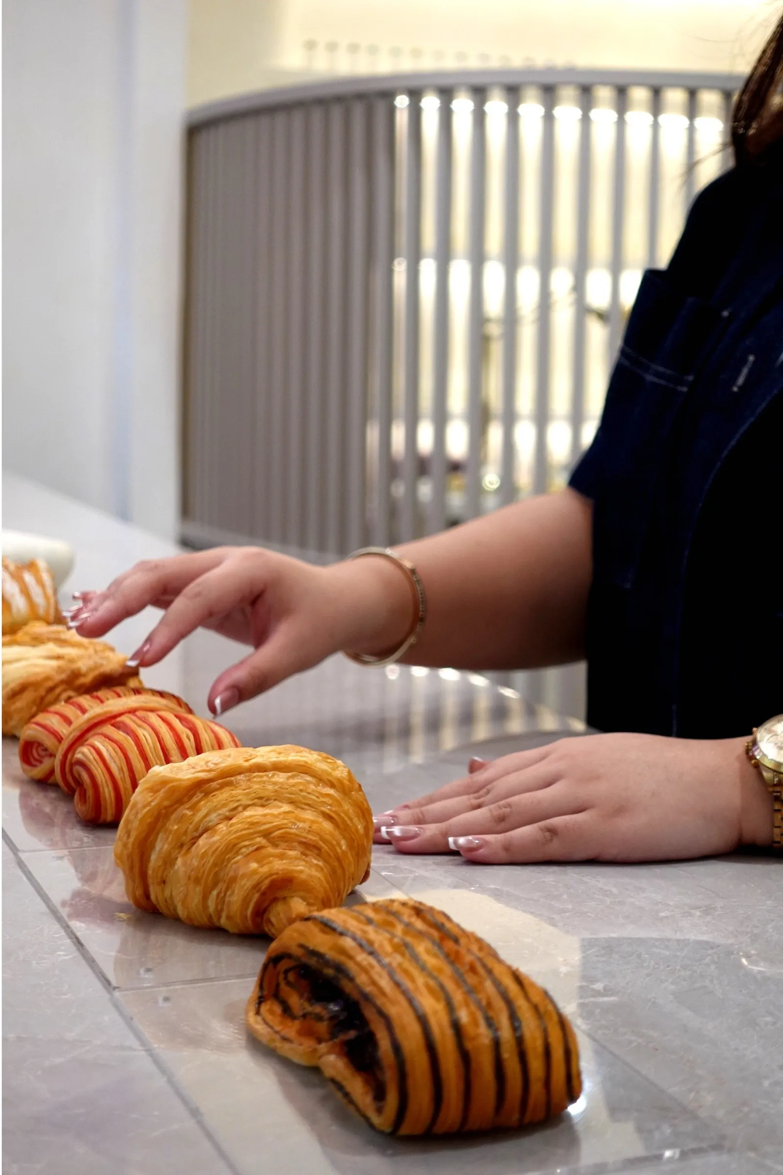 Croissants and pastries laid out on the marble counter at Lavande